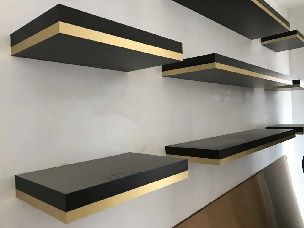 ebony-stained-floating-shelves-with-brass-detail-design