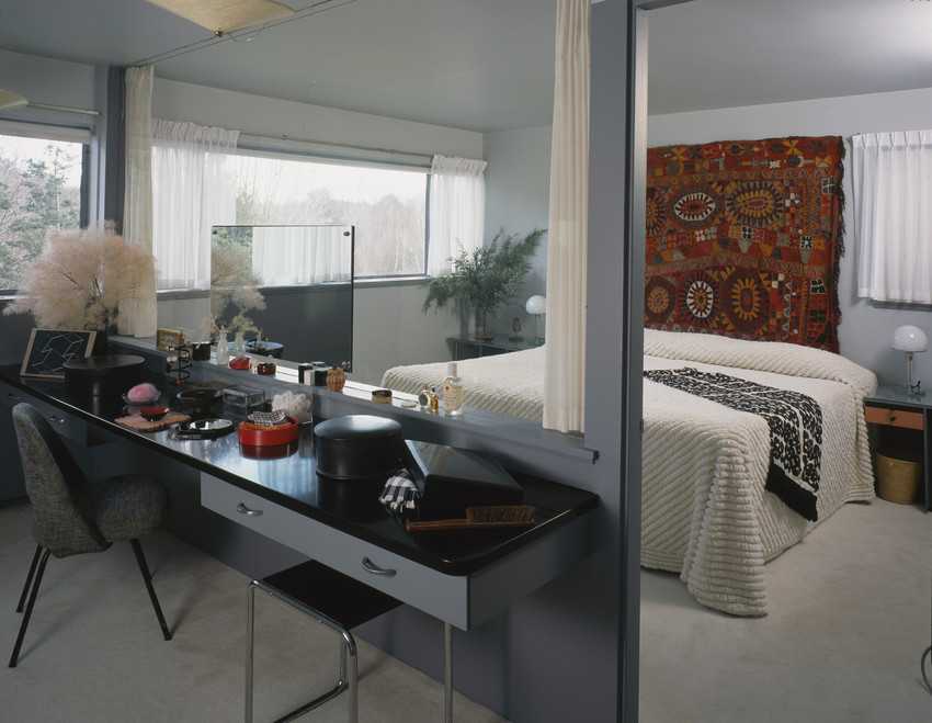 The Gropius House - Ribbon windows and an interior glass window keep the master bedroom feeling open, while a vibrant Iraqi wool rug, sheers and soft textures make it snug.