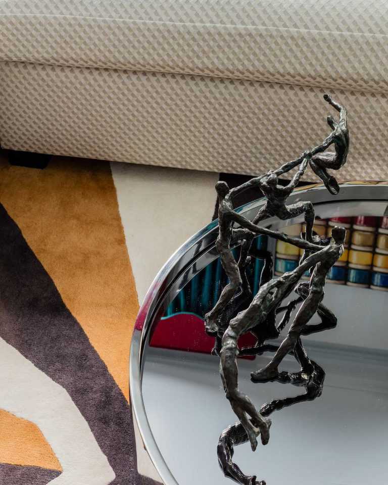 Detail of sculpture atop mirrored coffee table