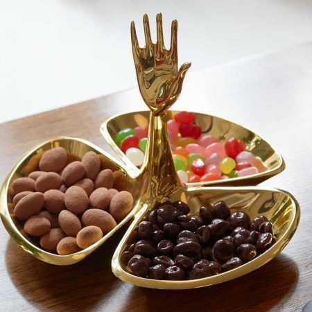 Brass candy dish with three dishes and raised hand that serves as its handle