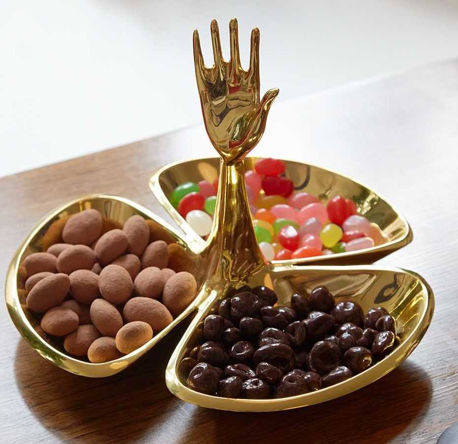 Brass candy dish with three dishes and raised hand that serves as its handle