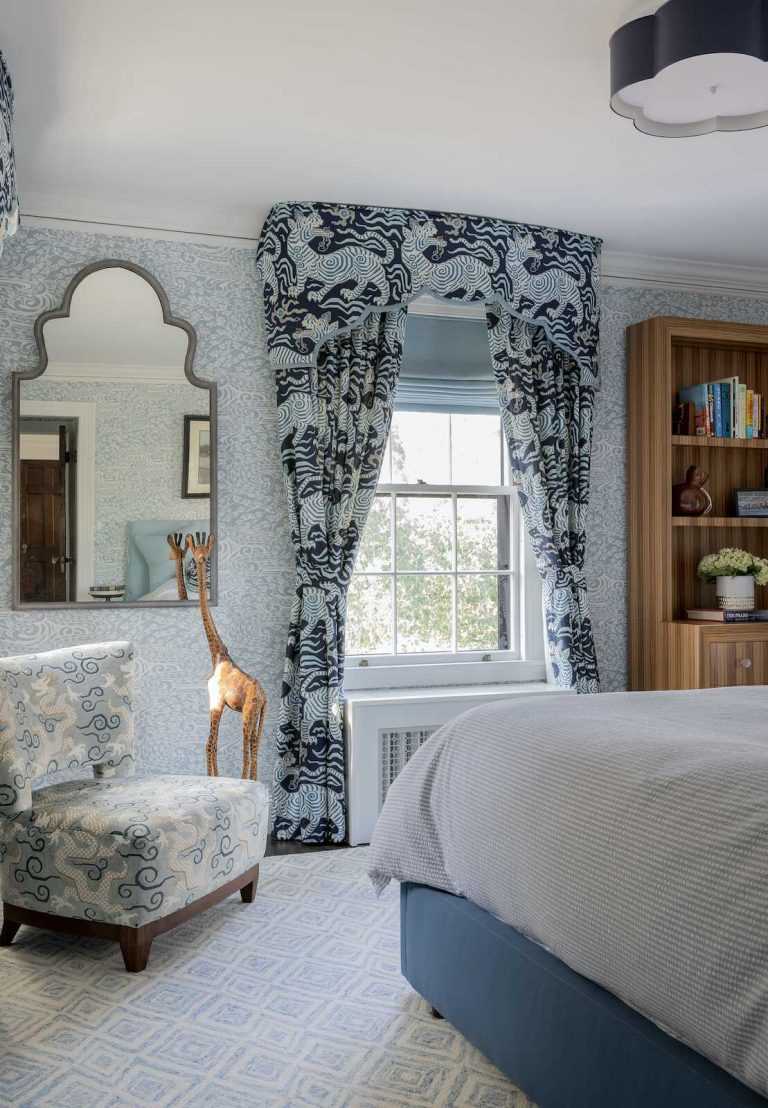 The windows in the guest bedroom are dressed with valances and curtains with whimsical tigers as well as roman shades.