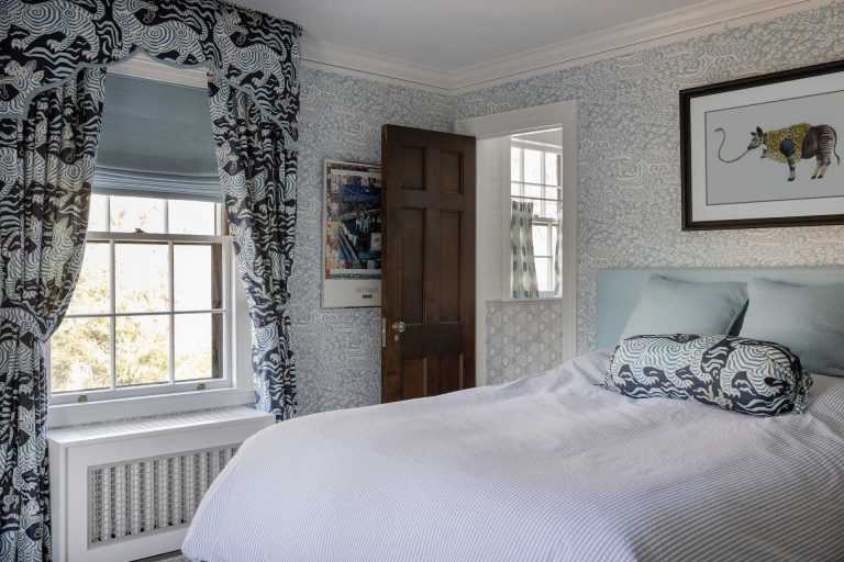 The guest bedroom has a playful vibe with a mixture of patterns and textures in a range of blues.